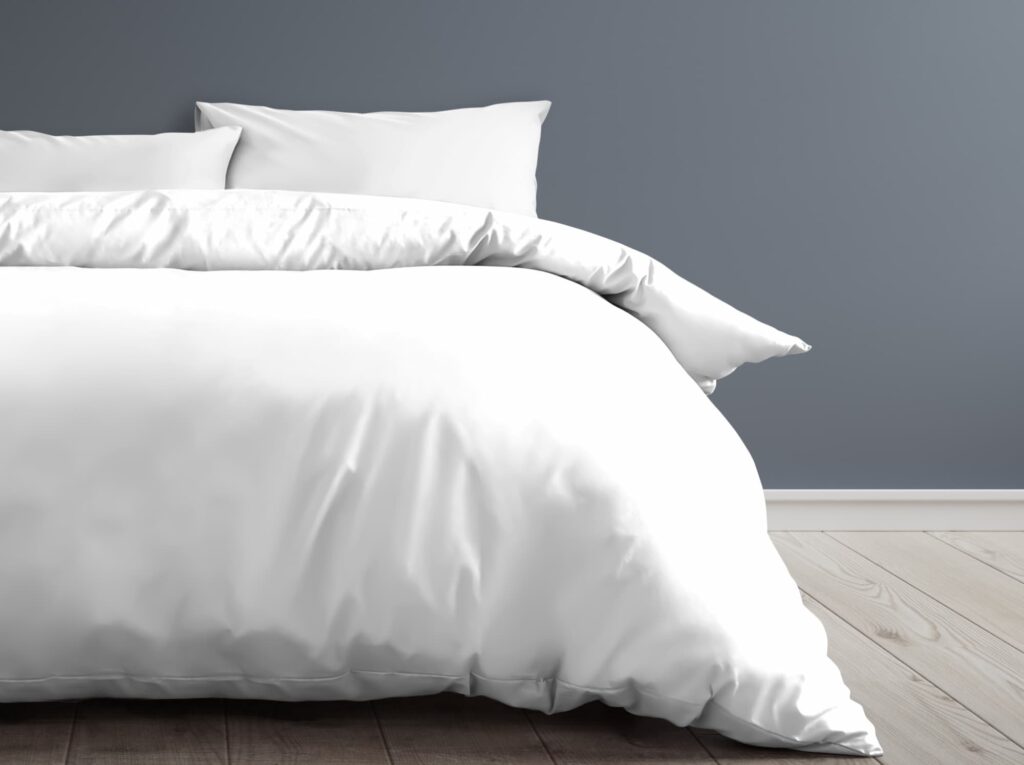 a white fluffy bed with a grey background